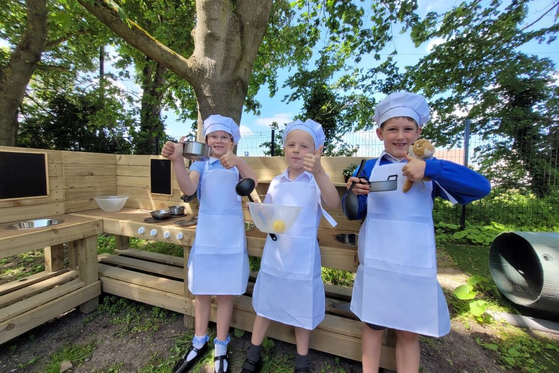 Children playing with mud kitchen